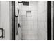 Walk-in shower with black fixtures and marble-style tile at 358 Roy Sw St, Atlanta, GA 30310