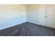 Spacious bedroom with gray carpet and double doors at 40 Eryn Ter, Covington, GA 30014