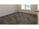 Empty bedroom with gray carpet and window at 40 Eryn Ter, Covington, GA 30014