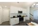 Clean kitchen featuring white cabinets, stainless steel appliances, and black countertops at 40 Eryn Ter, Covington, GA 30014