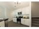 Modern kitchen with white cabinets, stainless steel appliances, and black countertops at 40 Eryn Ter, Covington, GA 30014