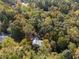 Aerial view of a two-story house surrounded by mature trees in a lush neighborhood setting at 34 Clay Ct, Villa Rica, GA 30180