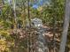 An aerial view shows the home's setting among mature trees with a long driveway at 34 Clay Ct, Villa Rica, GA 30180