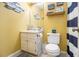 A charming yellow bathroom featuring nautical decorations and blue and white striped shower curtains at 34 Clay Ct, Villa Rica, GA 30180