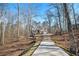 Long driveway leading to a two-story home surrounded by mature trees at 34 Clay Ct, Villa Rica, GA 30180