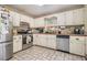 Bright kitchen features stainless appliances, white cabinets, and tiled floors, perfect for cooking at 34 Clay Ct, Villa Rica, GA 30180