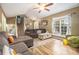 The cozy living room features vinyl floors, a ceiling fan, and an abundance of natural light at 34 Clay Ct, Villa Rica, GA 30180