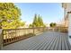 Outdoor wooden deck with surrounding trees and bright sky at 1188 Pine Acre Dr, Sugar Hill, GA 30518