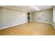 Basement area with patterned tile flooring, neutral paint and fluorescent lighting at 1188 Pine Acre Dr, Sugar Hill, GA 30518