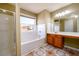 Bathroom with a large mirror, and a tub with tile surround and window at 1188 Pine Acre Dr, Sugar Hill, GA 30518
