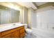 Bathroom with white shower and wood vanity at 1188 Pine Acre Dr, Sugar Hill, GA 30518