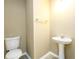 Neutral powder room featuring a pedestal sink and toilet at 1188 Pine Acre Dr, Sugar Hill, GA 30518