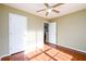 Bedroom with hardwood floors, ceiling fan, and neutral paint at 1188 Pine Acre Dr, Sugar Hill, GA 30518