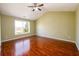 Bedroom with high ceiling, a ceiling fan, and hardwood flooring, and a large window at 1188 Pine Acre Dr, Sugar Hill, GA 30518