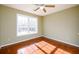 Bedroom featuring gleaming hardwood floors, a ceiling fan, and a window at 1188 Pine Acre Dr, Sugar Hill, GA 30518