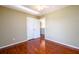 Bedroom featuring gleaming hardwood floors, ceiling fan, and doors at 1188 Pine Acre Dr, Sugar Hill, GA 30518