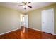 Bedroom with hardwood floors, ceiling fan, and neutral paint at 1188 Pine Acre Dr, Sugar Hill, GA 30518