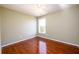 Bedroom featuring gleaming hardwood floors, a ceiling fan and a window at 1188 Pine Acre Dr, Sugar Hill, GA 30518