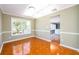 Sunlit dining room with wainscoting, tile flooring and large windows offering views of the outside at 1188 Pine Acre Dr, Sugar Hill, GA 30518