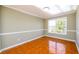 Corner view of a dining room featuring neutral walls, wainscoting, and tile flooring at 1188 Pine Acre Dr, Sugar Hill, GA 30518