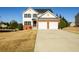 Beautiful two-story house with a well-manicured lawn and a two-car garage at 1188 Pine Acre Dr, Sugar Hill, GA 30518