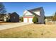 Exterior view of the home with a two-car garage and driveway at 1188 Pine Acre Dr, Sugar Hill, GA 30518