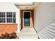 Inviting front entrance with a dark green door and brick accents at 1188 Pine Acre Dr, Sugar Hill, GA 30518