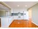 Updated kitchen with white cabinets, stainless appliances and tile floors at 1188 Pine Acre Dr, Sugar Hill, GA 30518