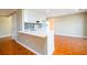 Well-lit kitchen with white cabinets, updated appliances, and breakfast bar overlooking an open room at 1188 Pine Acre Dr, Sugar Hill, GA 30518