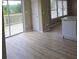 Bright kitchen area with sliding glass doors, stainless steel dishwasher, and wood flooring at 1188 Pine Acre Dr, Sugar Hill, GA 30518