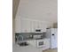 Well-lit kitchen featuring white cabinets, stainless appliances, and backsplash at 1188 Pine Acre Dr, Sugar Hill, GA 30518