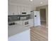 Well-lit kitchen featuring white cabinets, stainless appliances, and backsplash at 1188 Pine Acre Dr, Sugar Hill, GA 30518