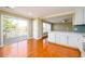 Bright eat-in kitchen featuring white cabinetry, modern appliances, and sliding door access to the balcony at 1188 Pine Acre Dr, Sugar Hill, GA 30518