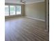 Bright living room with large windows, ceiling fan and beautiful wood-look flooring at 1188 Pine Acre Dr, Sugar Hill, GA 30518