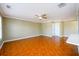 Spacious living room with crown molding, tile flooring, and a ceiling fan for a comfortable atmosphere at 1188 Pine Acre Dr, Sugar Hill, GA 30518