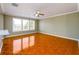 Living room featuring ceramic tile flooring and a ceiling fan with large windows at 1188 Pine Acre Dr, Sugar Hill, GA 30518