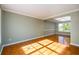 Bright living room with tile floors, fresh paint and lots of natural light from a large window at 1188 Pine Acre Dr, Sugar Hill, GA 30518