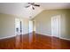 Large main bedroom featuring ceiling fan, hardwood floors, and dual doors at 1188 Pine Acre Dr, Sugar Hill, GA 30518