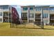 View of the backyard featuring a black metal fence and the back exterior of the townhomes at 309 Creekbank Se Way, Smyrna, GA 30082