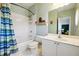 Bathroom featuring bathtub, toilet, single sink vanity and storage shelving at 309 Creekbank Se Way, Smyrna, GA 30082