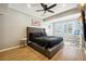 Bright bedroom featuring a ceiling fan, neutral paint, and wood floors at 309 Creekbank Se Way, Smyrna, GA 30082