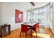 Bright dining room with hardwood floors, wooden table, red chairs, and modern light fixture at 309 Creekbank Se Way, Smyrna, GA 30082