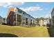 View of townhouse exteriors with fenced yards, decks/patios, and tidy landscaping at 309 Creekbank Se Way, Smyrna, GA 30082