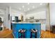 Beautiful kitchen with white cabinets, stainless steel appliances, and blue island with bar stool seating at 309 Creekbank Se Way, Smyrna, GA 30082