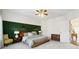 Serene main bedroom features carpet, a wood-accent wall and natural light at 309 Creekbank Se Way, Smyrna, GA 30082