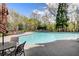 Community pool area featuring lounge chairs and tables for relaxation by the water at 309 Creekbank Se Way, Smyrna, GA 30082