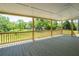 A spacious back porch with wooden floors and railings offers great views of the landscaped backyard at 2334 Highway 278, Social Circle, GA 30025
