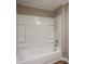 Clean bathroom featuring a bright white shower-tub, with chrome hardware and clean white paneling at 2334 Highway 278, Social Circle, GA 30025