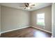 Bedroom with wood-look floors, a ceiling fan, and a large window at 2334 Highway 278, Social Circle, GA 30025