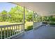 Inviting covered front porch overlooking a well-maintained lawn and lush greenery at 2334 Highway 278, Social Circle, GA 30025